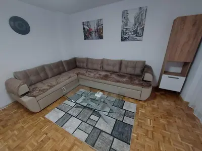 a living room with a couch and a glass table at Apartman Borik in Banja Luka