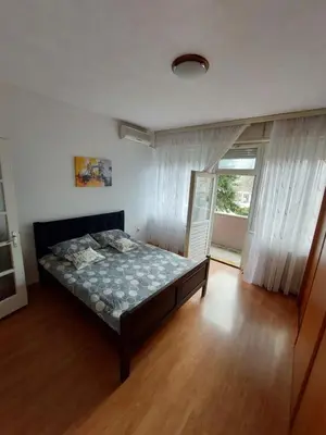 a bedroom with a bed in a room with a window at Index 3 in Banja Luka
