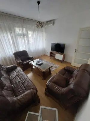 a living room with two leather couches and a coffee table at Index 3 in Banja Luka