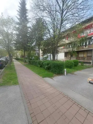 a sidewalk in front of a building with trees at Index 3 in Banja Luka