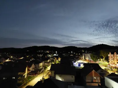 a view of a city at night at Apartman Aurora in Modriča