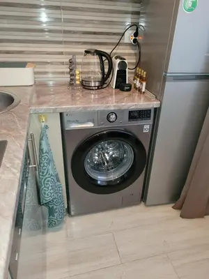 a washing machine in a kitchen with a counter at City Center Moku Apartman in Zenica