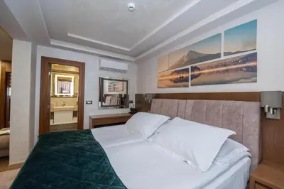 a bedroom with a large white bed in a room at Hotel Park in Srebrenik
