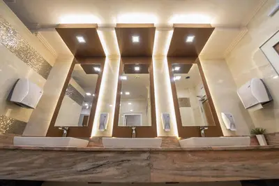 a bathroom with three sinks and a large mirror at Hotel Park in Srebrenik