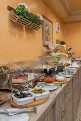 a buffet line with plates of food on it at Hotel Park in Srebrenik