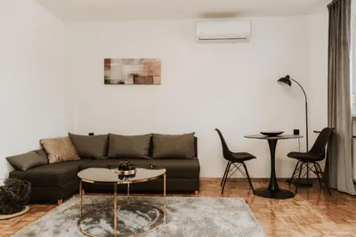 a living room with a couch and a table at Apartman at 8th in Banja Luka