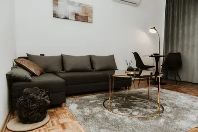 a living room with a couch and a table at Apartman at 8th in Banja Luka
