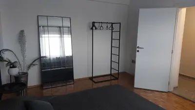 a living room with a room with a ladder and a mirror at Apartman at 8th in Banja Luka