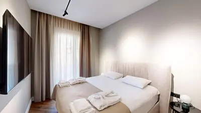 a bedroom with a bed with towels on it at Ideal Apartments in Banja Luka