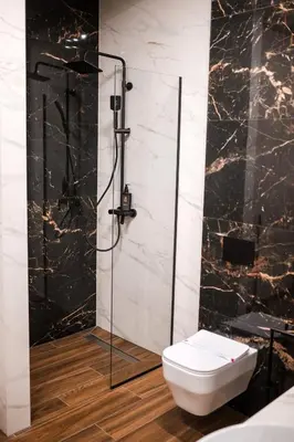 a bathroom with a toilet and a glass shower at Ideal Apartments in Banja Luka