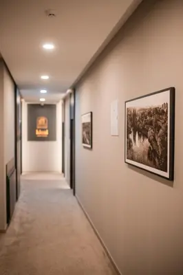 a hallway with paintings on the walls at Ideal Apartments in Banja Luka