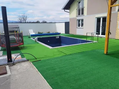 a backyard with a swimming pool and green grass at Halal Holidey Kuća za odmor in Spahići