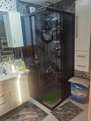 a bathroom with a shower with a green floor at Halal Holidey Kuća za odmor in Spahići