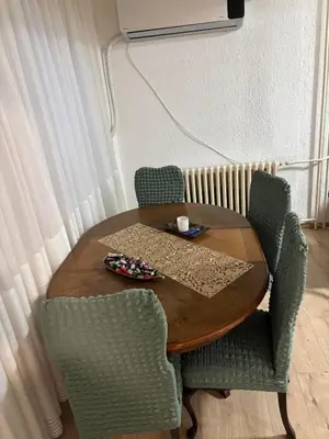 a wooden table with two chairs and a tableasteryasteryasteryasteryasteryasteryastery at Apartman Centar in Banja Luka