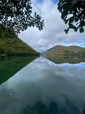 a view of a lake with hills in the distance at Plivska vila 2 in Jajce