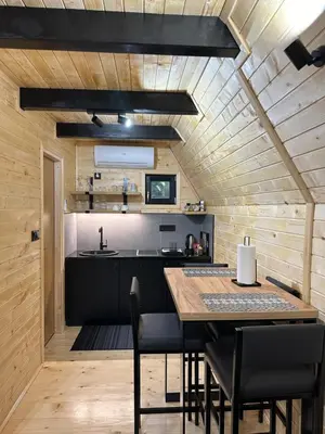 a kitchen and dining room with a table and chairs at Plivska vila 2 in Jajce