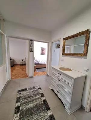 a bathroom with a sink and a mirror on the wall at Apartman Bulevar Banjaluka in Banja Luka