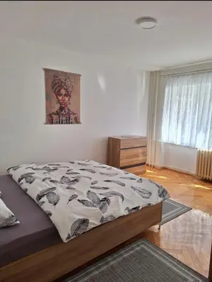 a bedroom with a bed and a painting on the wall at Apartman Bulevar Banjaluka in Banja Luka