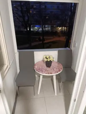 a table and two chairs and a table with flowers on it at Apartman Bulevar Banjaluka in Banja Luka