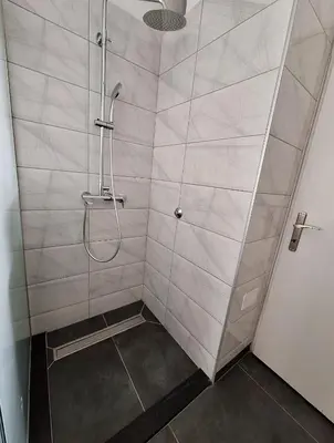 a bathroom with a shower with a glass door at Apartman Bulevar Banjaluka in Banja Luka