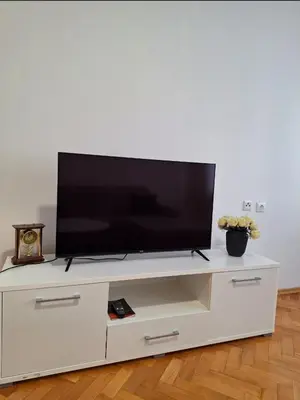 a flat screen tv sitting on a white entertainment center at Apartman Bulevar Banjaluka in Banja Luka