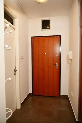 a wooden door in a room with a hallway at Apartman Atrium Banja Luka in Banja Luka