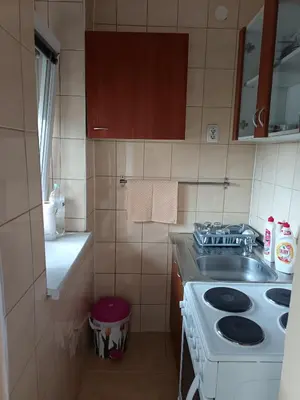 a small kitchen with a stove and a sink at City apartmant in Tuzla