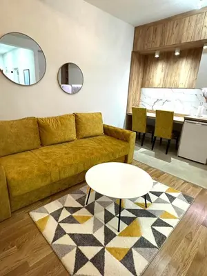 a living room with a couch and a table at Apartman Most in Bosanska Gradiška