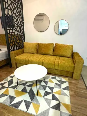 a living room with a couch and a table and a mirror at Apartman Most in Bosanska Gradiška