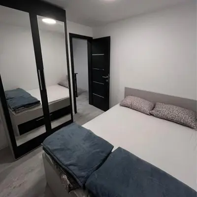 a bedroom with a bed and a mirror in it at Villa Imperia for rent - Banja Luka Krupa na Vrbasu in Krupa na Vrbasu