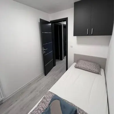 a bedroom with a white bed and a black cabinet at Villa Imperia for rent - Banja Luka Krupa na Vrbasu in Krupa na Vrbasu