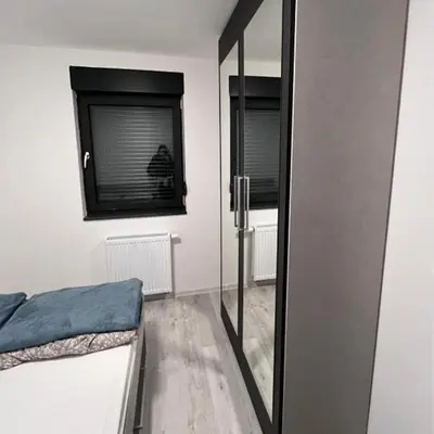 a bedroom with a mirror and a bed and a window at Villa Imperia for rent - Banja Luka Krupa na Vrbasu in Krupa na Vrbasu