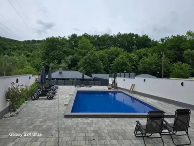 a swimming pool on a patio with chairs around it at Villa Imperia for rent - Banja Luka Krupa na Vrbasu in Krupa na Vrbasu