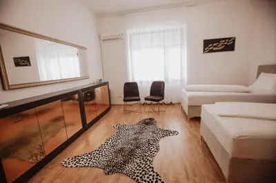 a living room with a leopard rug on the floor at Apartman Eden Bihać in Bihać