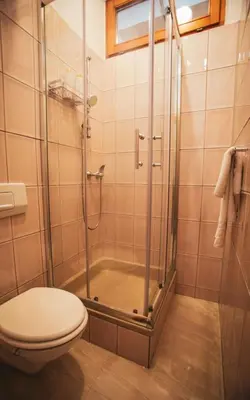 a bathroom with a shower and a toilet at Apartman Eden Bihać in Bihać