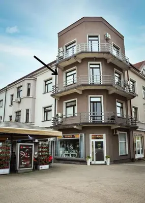 a large building with a balcony on top of it at Apartman Eden Bihać in Bihać
