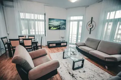 a living room with two couches and a table at Apartman Eden Bihać in Bihać