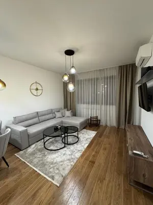 a living room with a couch and a table at Apartman DK VIII in Banja Luka