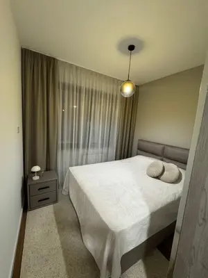a bedroom with a bed with two pillows on it at Apartman DK VIII in Banja Luka