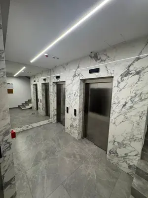 a large room with marble walls and doors in a building at Apartman DK VIII in Banja Luka