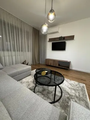 a living room with a couch and a table at Apartman DK VIII in Banja Luka
