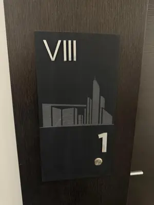 a black wall clock with a picture of a city at Apartman DK VIII in Banja Luka