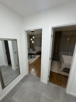 a room with a mirror and a room with a bed at Apartman DK VIII in Banja Luka