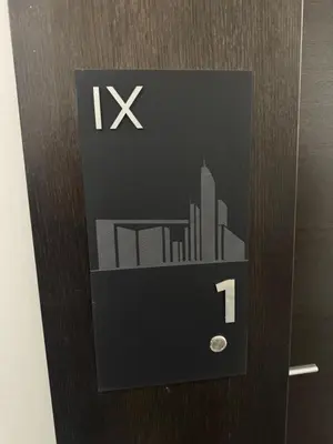 a door with a sign with a city on it at Apartman AK IX in Banja Luka