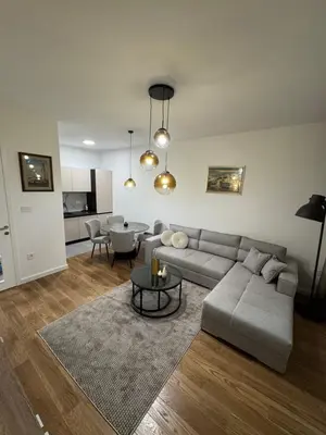 a living room with a couch and a table at Apartman AK IX in Banja Luka
