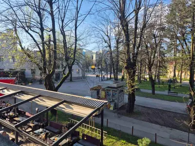 a view of a park with a building and trees at Apartman Bosiljak in Banja Luka