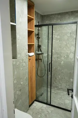 a shower with a glass door in a bathroom at Apartman Bosiljak in Banja Luka