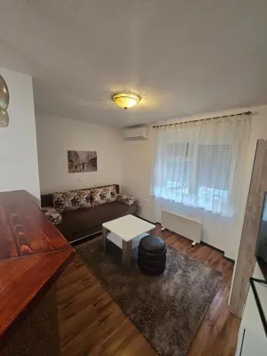 a living room with a couch and a table at Apartman Sanus in Sanski most