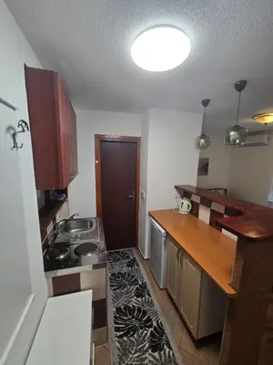 a kitchen with a sink and a stove in it at Apartman Sanus in Sanski most