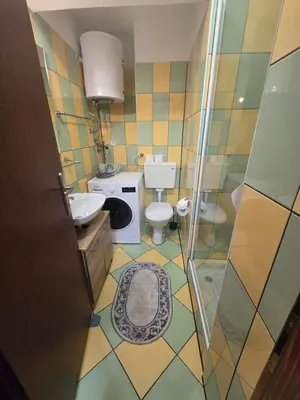 a small bathroom with a toilet and a sink at Apartman Sanus in Sanski most